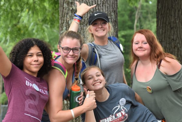 Campers smiling and waving